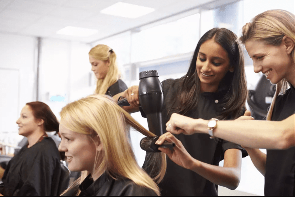 Dedicated hairstylist apprentice gaining hands-on hairsalon experience in the art of hairdressing